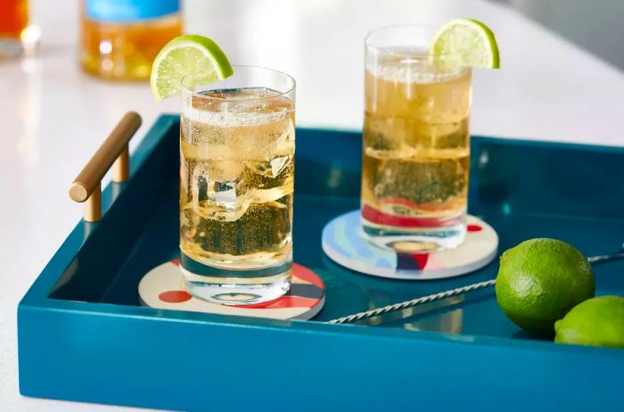 Highball glasses are designed for light, bubbly drinks, often garnished with a fresh lime slice.