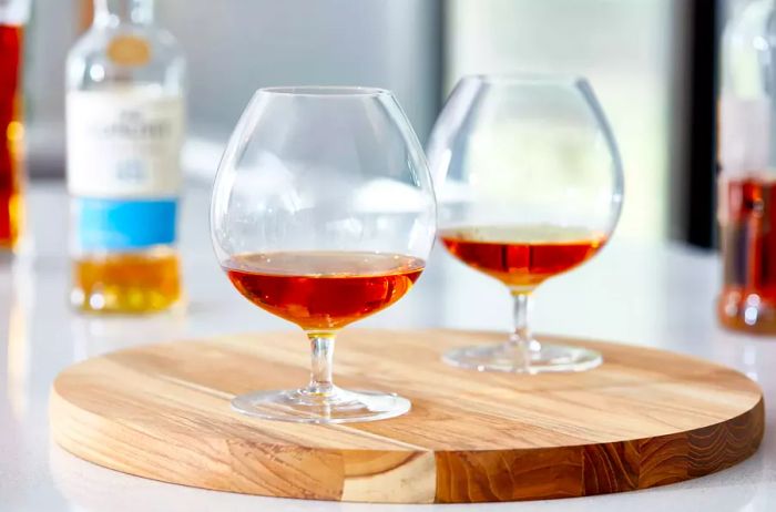 Snifter glasses resting on a wooden surface