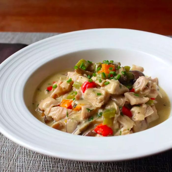 A bowl of creamy chicken with mixed vegetables