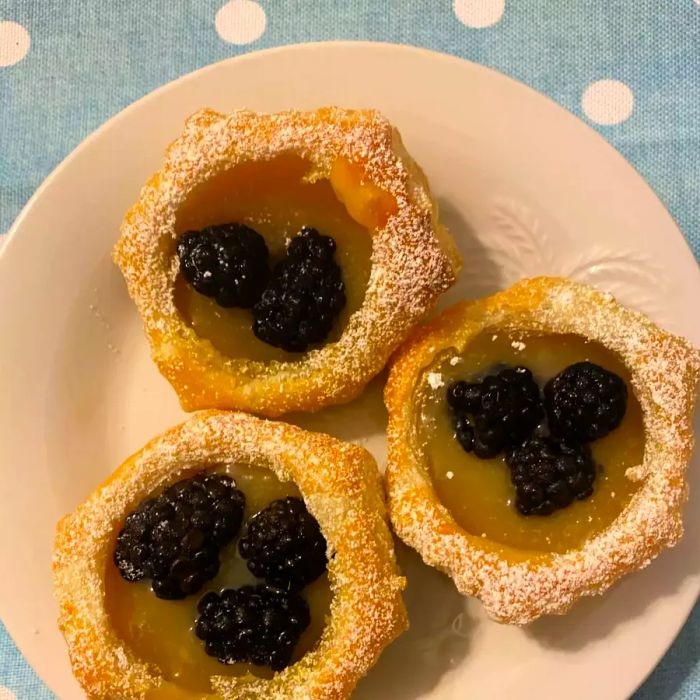 Lemon Berry Tartlets on a white plate, ready to serve