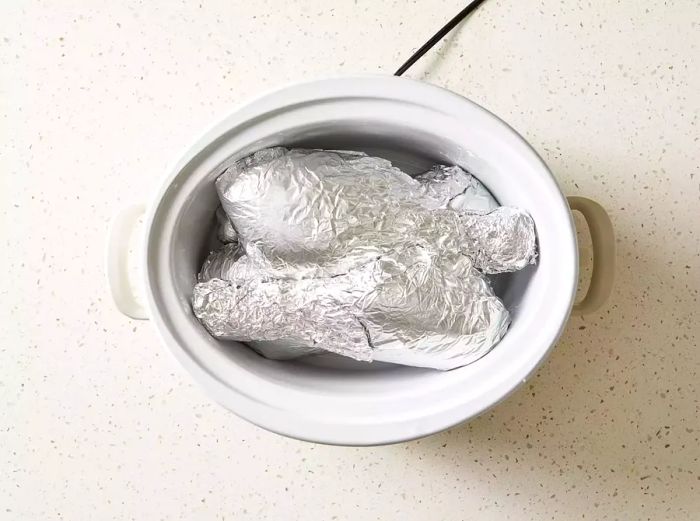 Turkey Legs Wrapped in Aluminum Foil in a Slow Cooker