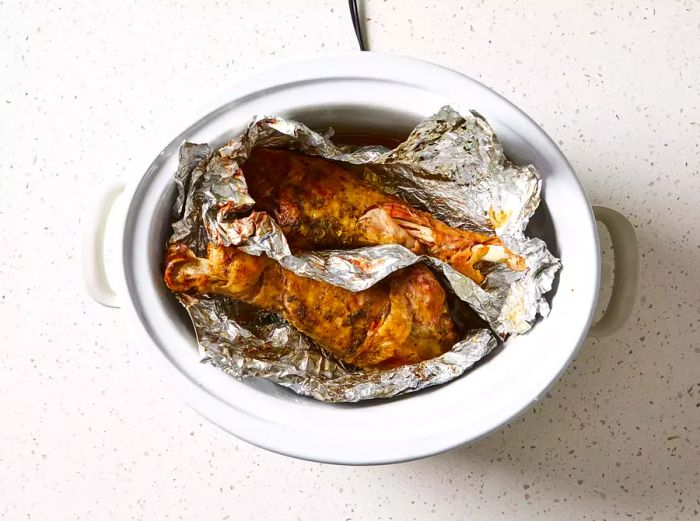 Slow Cooker Turkey Legs with Foil Wrapped Around Them