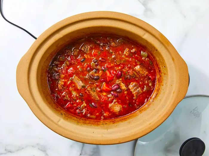 Beef broth added to adjust the chili's thickness in the slow cooker