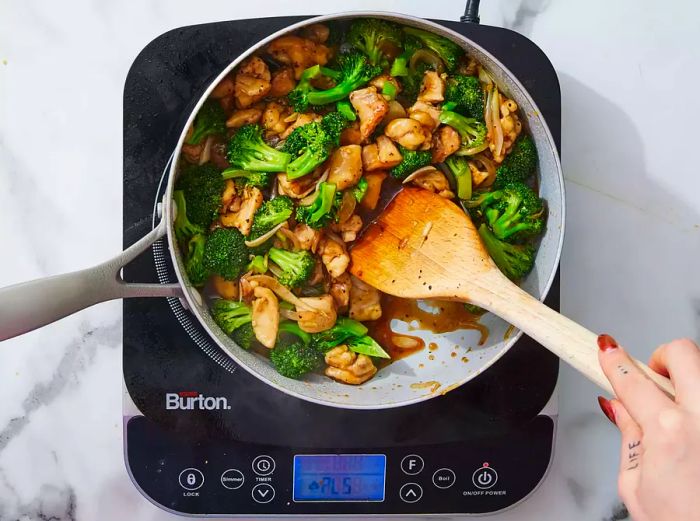 Chicken, broccoli, and sauce mixture added to the skillet and stirred until fully coated.