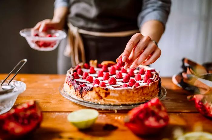 Topping a Blackberry Pie with Fresh Raspberries