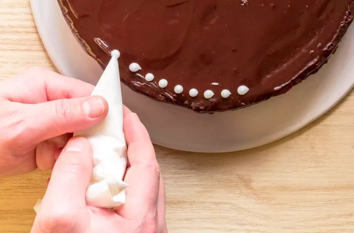 Decorating a cake with icing using a homemade piping bag