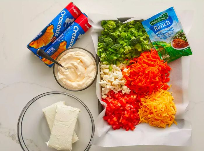 Aerial view of the ingredients measured and ready for the vegetable pizza