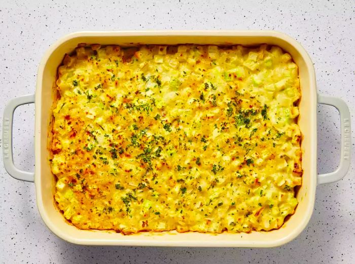 A finished zucchini soufflé, beautifully garnished with parsley and paprika on top.