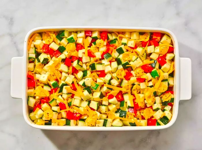 A baking dish filled with the zucchini and bell pepper mixture