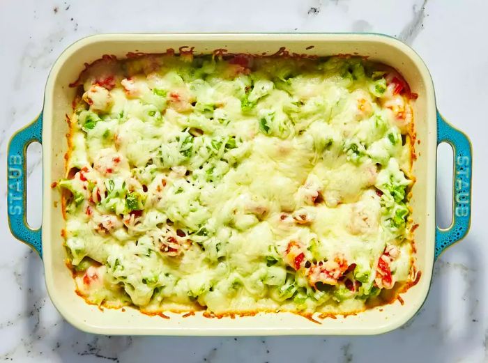 A casserole dish filled with zucchini and cheese, ready to serve.