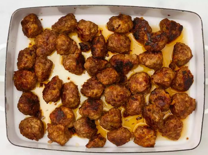 Overhead view of Swedish Meatballs (Svenska Köttbullar) baked and ready to serve in a dish.