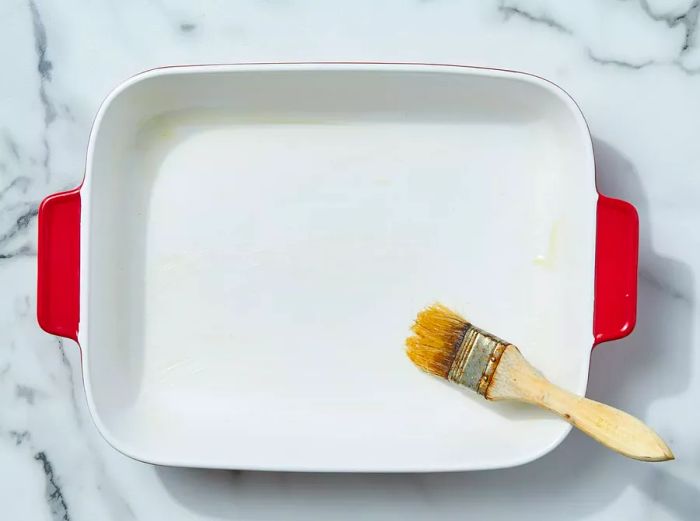 Lightly coat a baking dish with grease.