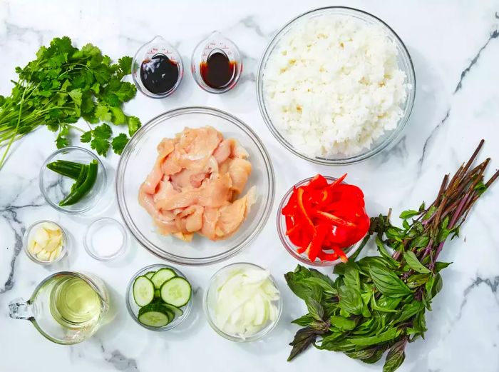 All ingredients prepared for making Thai spicy basil chicken fried rice.