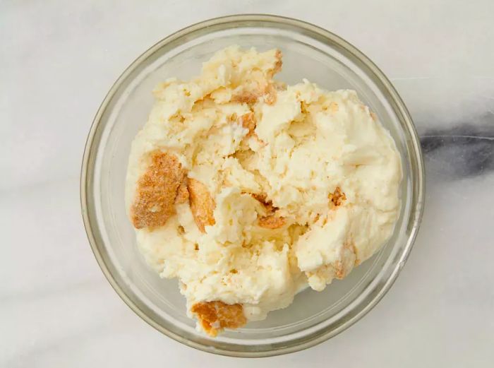 Aerial shot of a bowl containing breadcrumbs and cream for the Swedish Meatballs (Svenska Köttbullar) recipe.