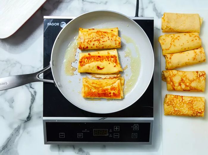 Melted butter in the skillet, adding a few blintzes at a time and turning until golden brown.