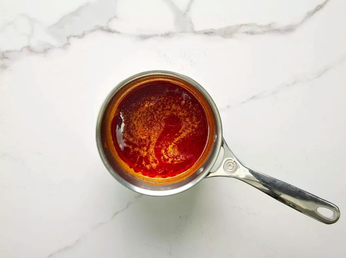 High-angle shot of a small pot with Nashville hot chicken sauce