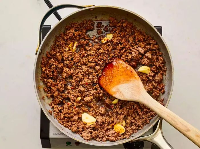 A skillet of seasoned ground beef with soy sauce, brown sugar, and red pepper