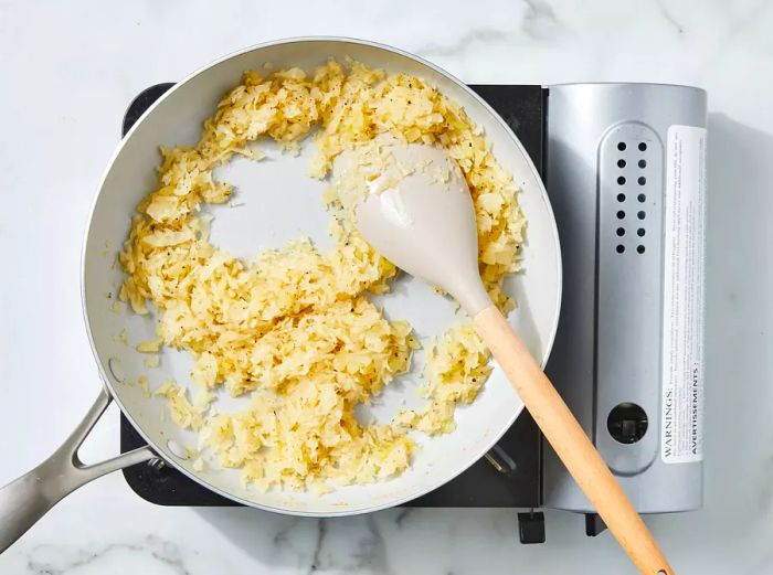 Sauerkraut filling cooking in a skillet