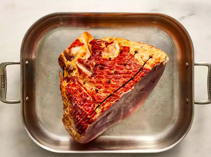 Ham in the roasting pan with cloves inserted