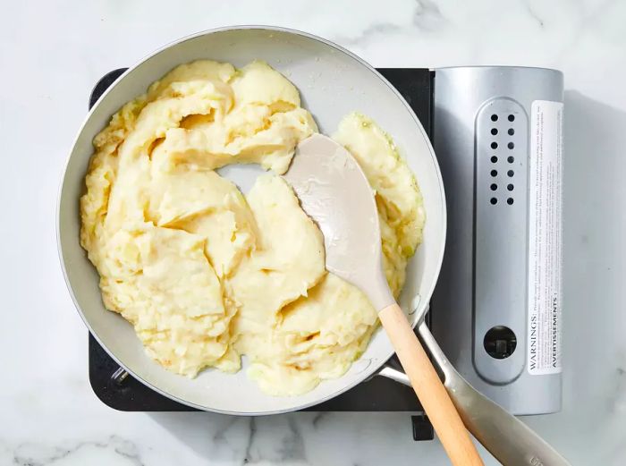 Potato filling being prepared in the same skillet