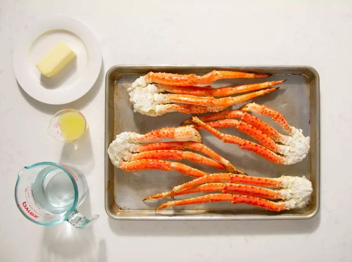 Aerial view of crab leg ingredients arranged in bowls and containers.