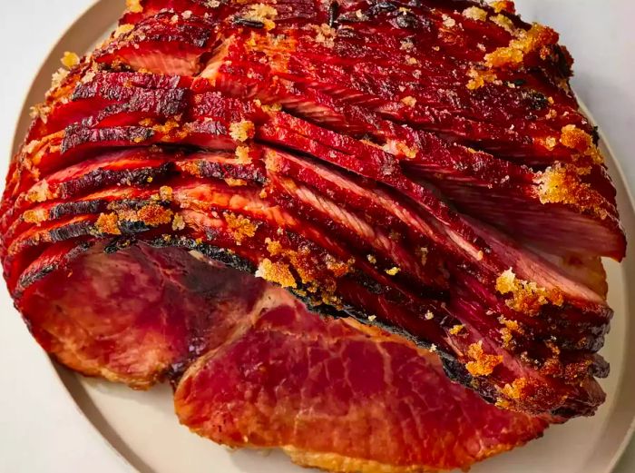 High-angle view of baked ham with a few slices cut