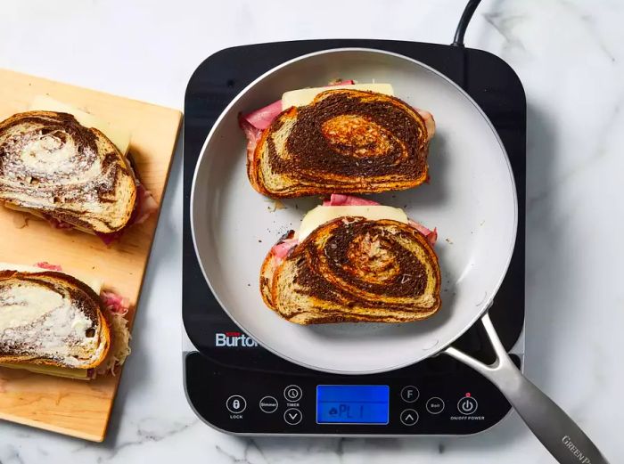 Bread tops buttered and placed, butter-side down, on a hot griddle