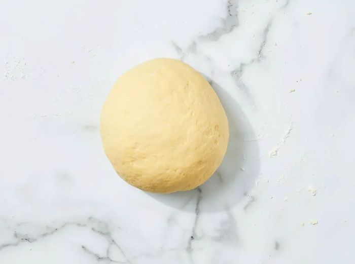 The dough is kneaded until it becomes firm and smooth.