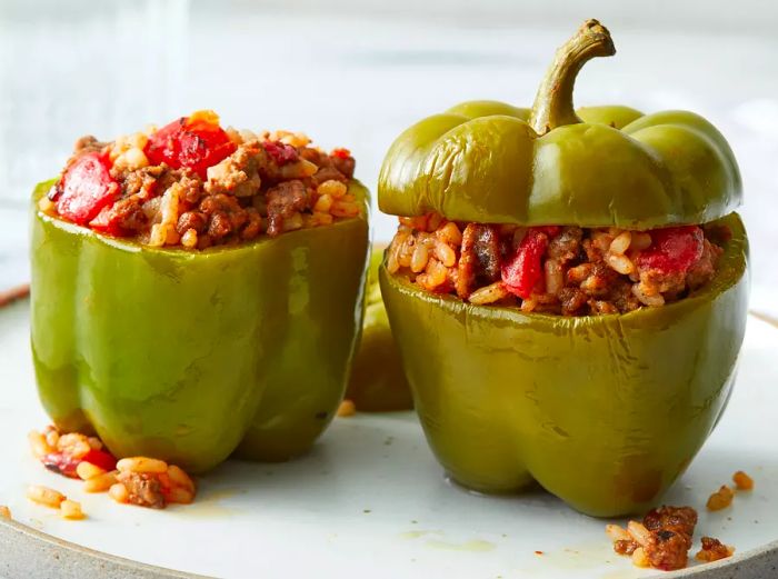 Side view of stuffed green peppers elegantly plated.