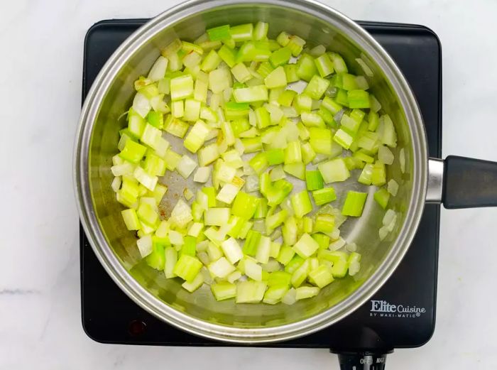 Sautéed celery and onion in the pan