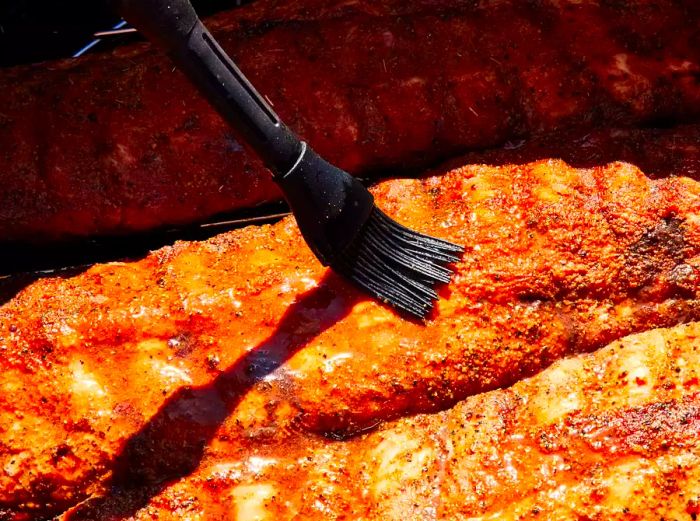 Brush the ribs with sauce and baste them every 30 to 40 minutes.