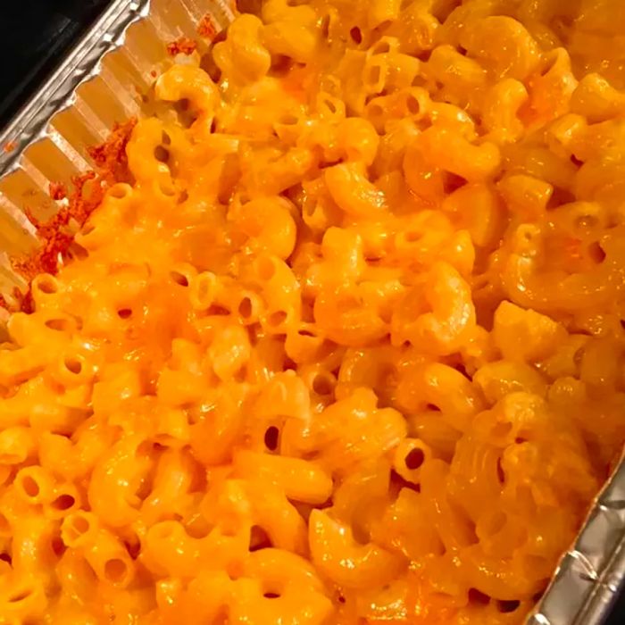 Close-up shot of baked macaroni and cheese in an aluminum baking pan.