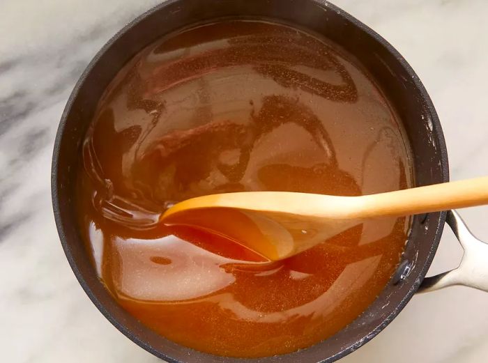 Top-down shot of a pan with the sauce for shrimp egg foo young cooking