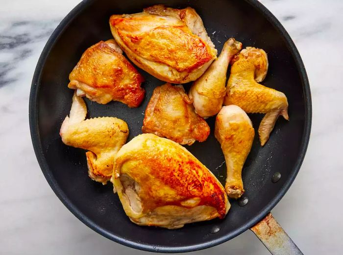 Golden-browned chicken in the skillet