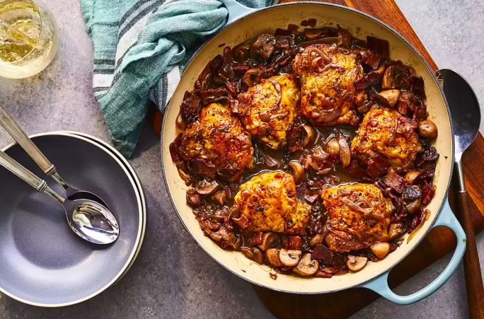 A top-down view of Chef John’s Coq au Vin simmering in a pot.