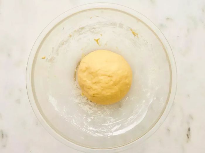 Dough kneaded and placed in a floured glass bowl