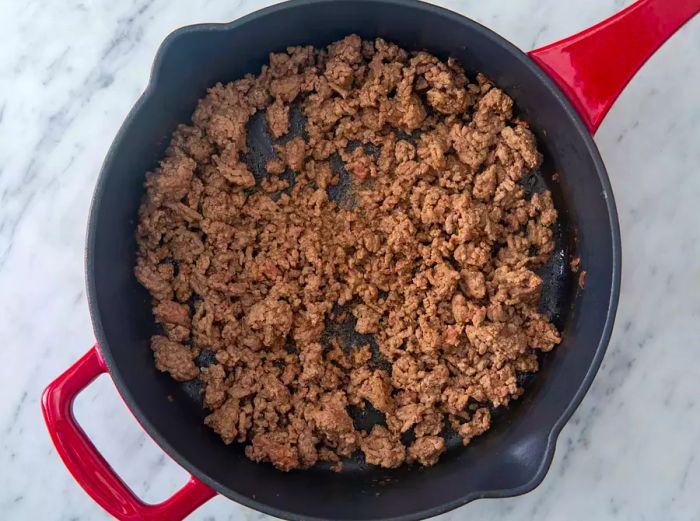 Cook the ground beef until it's browned and crumbled.