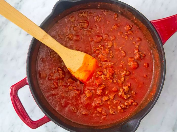 Tomato sauce, garlic salt, sugar, and salt combined with the ground beef.