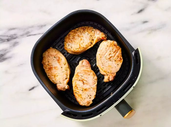 Pork chops cooked in batches, until they reach the desired internal temperature.