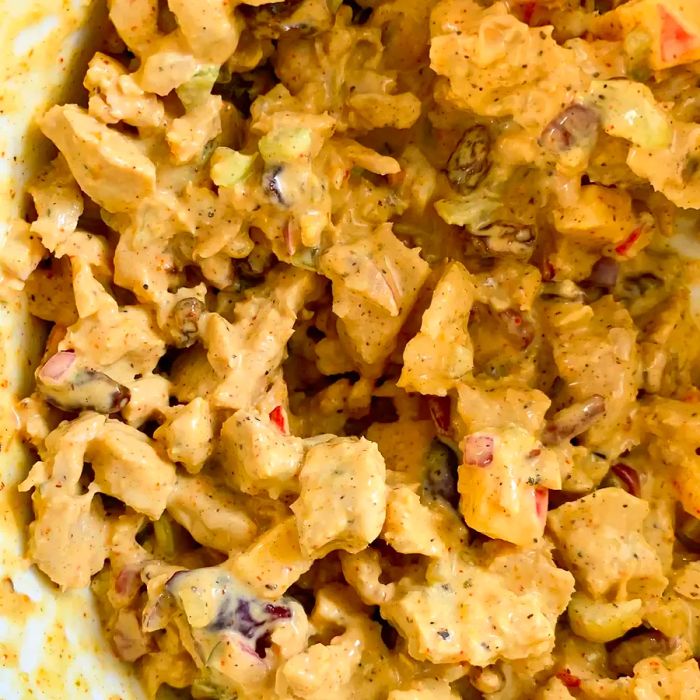 Close-up shot of Curried Chicken Salad with Fruit served in a white bowl