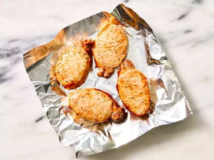 Transfer the pork chops to a foil-lined plate and let them rest before serving.