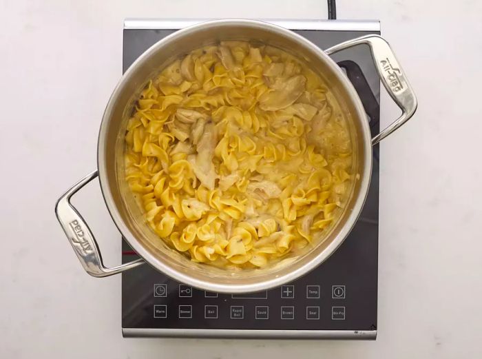 A pot of easy chicken and noodles simmering on the stove.