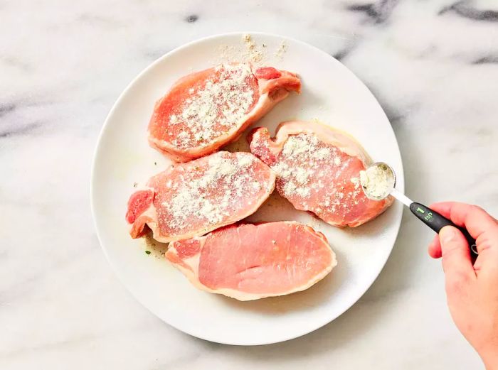 Both sides of the pork chops are coated with ranch seasoning mix.