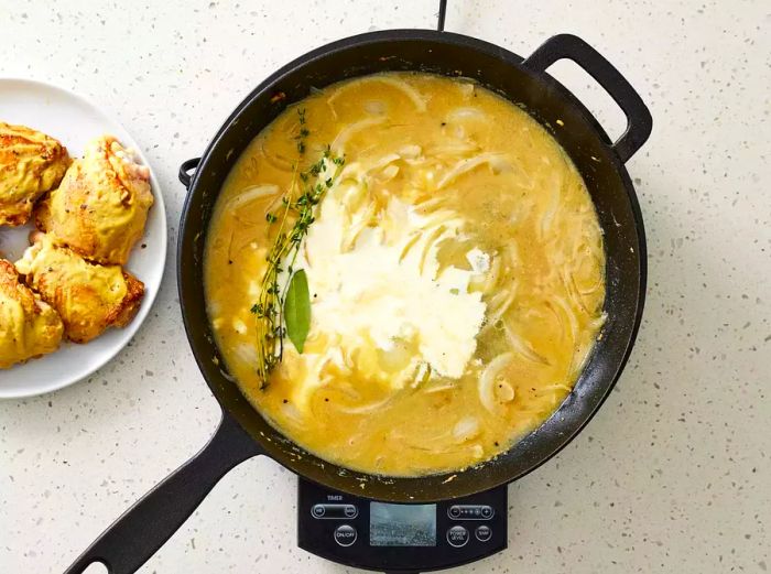 Dijon Chicken sauce simmering in a pan on a burner