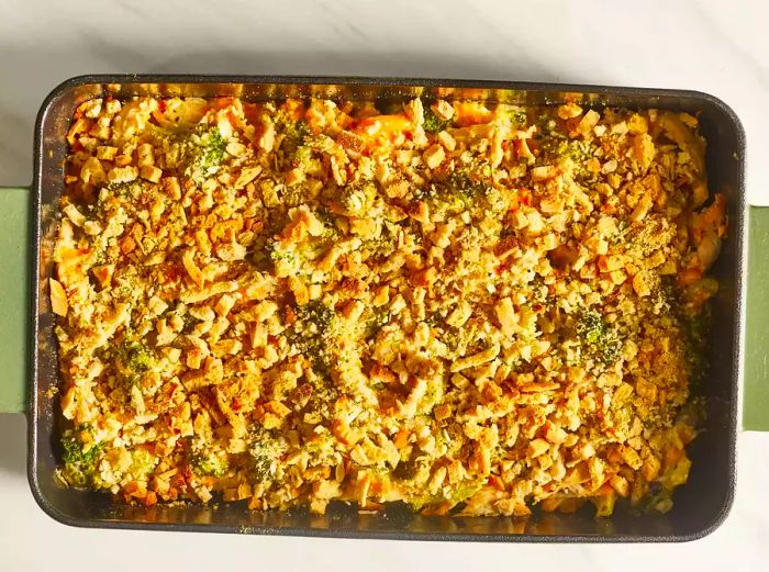 An overhead shot of a golden, baked chicken casserole in its dish, fresh out of the oven.