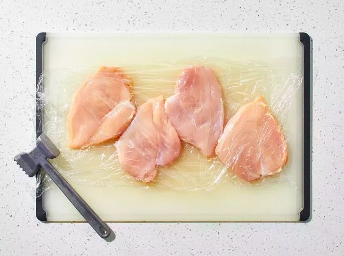 Chicken breasts flattened to an even thickness.