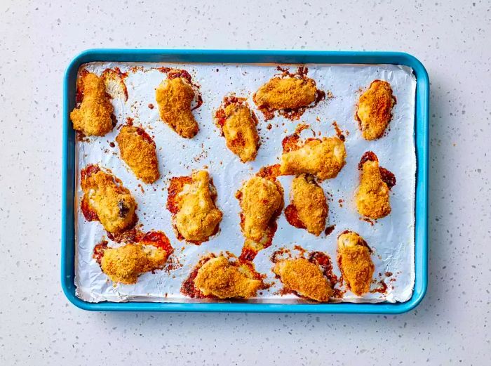 Oven-Baked Chicken Wings on a baking sheet lined with aluminum foil