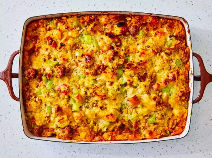 A baking dish with golden-brown Southern Italian Thanksgiving stuffing