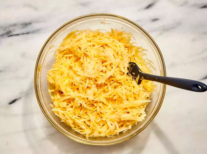 A large mixing bowl filled with potato pancake batter