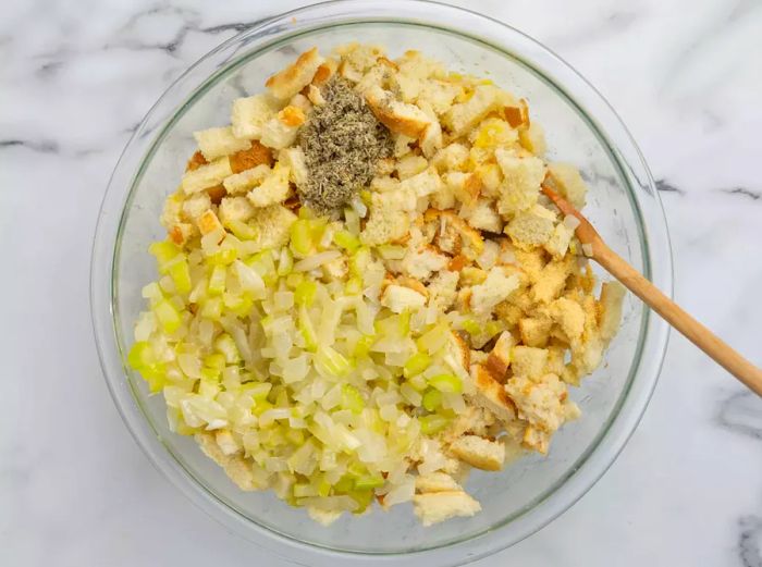 An overhead shot of stuffing ingredients being mixed in a bowl.